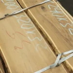 Unedged acacia board showing natural wood color and handwritten chalk markings.
