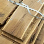 Extra grade unedged acacia boards stacked together and secured with a plastic strap.