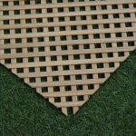 Decorative grille made of oak slats with a rectangular pattern, against a backdrop of artificial turf.
