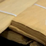 Close-up view of bound packs of 0.6 mm sliced anegre veneer sheets