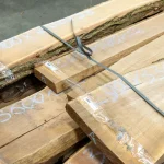 Texture of grade 1 unedged acacia board in a bundle at the warehouse