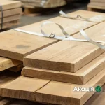 Stack of grade 1 edged acacia lumber stored in a warehouse
