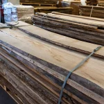 Kiln dried 52 mm unedged elm boards stacked in a warehouse