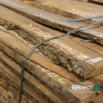 Grade 1, 52 mm unedged elm lumber boards stacked in a warehouse