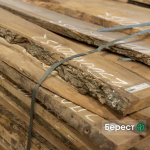 Grade 1, 52 mm unedged elm lumber boards stacked in a warehouse