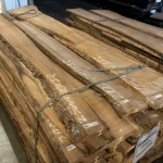 Grade 1, 52 mm unedged elm boards stacked in a warehouse