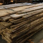 Stack of 52 mm unedged elm boards bound together in a warehouse