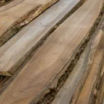 Kiln dried grade 1, 52 mm elm unedged board showing natural bark edges