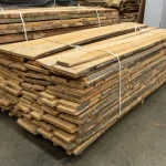 A stack of 52 mm unedged beech lumber stored in a warehouse.