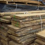 Stack of 52 mm grade 1 unedged beech boards in a warehouse.