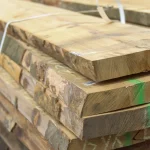 Close-up view showing the thickness and edges of first grade 52 mm unedged beech boards in a stack.