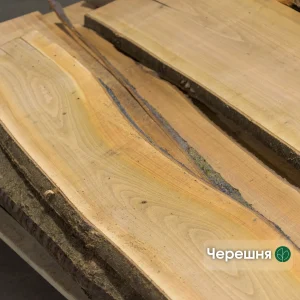Unedged cherry wood board of Grade 1 showing beautiful natural grain and waney edge.