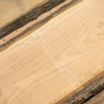 Close-up of the smooth surface and beautiful grain of a red oak unedged board.
