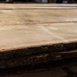 Stacked 52 mm grade 1 unedged oak boards showing natural bark on the edge