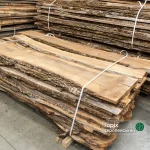 52 mm unedged European walnut boards stored in a warehouse stack