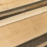 Close-up of the smooth light surface and fine grain of an extra grade unedged maple board.