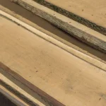 Close-up of the clean, light-colored wood grain and natural edge of premium maple boards.