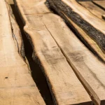 Several unedged linden boards laid out side-by-side, highlighting their natural waney edges.