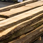Stack of extra grade unedged linden boards stored in a warehouse.