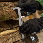 Measuring the thickness of an unedged linden board with a vernier caliper.
