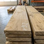 Length of stacked 52 mm edged elm boards stored in a warehouse