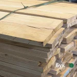 Stack of first grade 52 mm beech edged boards bound together in a warehouse.