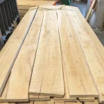 A stack of light edged beech boards, 52 mm, of first grade in a warehouse