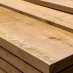 Close-up of a dry edged cherry board showing wood grain texture and chalk markings.