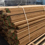 A neatly stacked and strapped bundle of edged cherry lumber boards on a pallet.