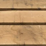 Top-down view of three parallel red oak edged boards with handwritten markings.