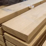 Close-up of the end grain and smooth texture of premium edged red oak boards.