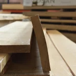 Width of kiln dried extra grade 52 mm oak edged boards stored in a warehouse.