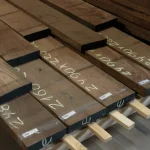 Dimensions marked on American walnut edged boards, 54 mm, stored in a warehouse