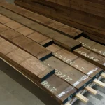 Edged American walnut lumber, 54 mm, stacked in a warehouse