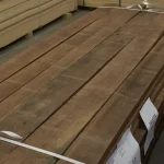 Joinery American walnut boards 55 mm stacked in a warehouse