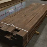Kiln-dried American walnut edged furniture boards 55 mm stacked in a warehouse