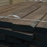 Thickness of American walnut edged boards (55 mm) bound in a bundle with straps