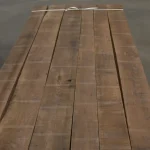 Kiln dried American walnut edged boards 52 mm bound in a stack for furniture and flooring