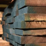 Thickness of American walnut edged boards (52 mm) stacked in a warehouse