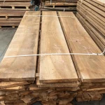 Texture of grade 1 European walnut boards, 52 mm, in a warehouse stack