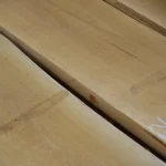 Close-up of the smooth surface and fine grain of dry edged maple boards.