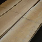 Parallel premium edged maple lumber boards with smooth surface finish.