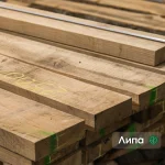 A close-up of stacked first-grade edged linden boards showing wood texture.