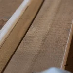 Close-up of the rough-sawn surface texture of an edged spruce board.