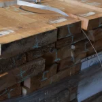 Ends of stacked edged spruce boards showing the thickness and clean cut quality.