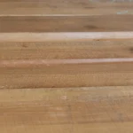 Detailed texture of the clean, smooth surface of Extra grade edged spruce boards.