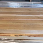 Side profile of the spruce lumber stack highlighting the precise thickness and straight edges.