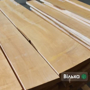 Close-up of the smooth surface of first-grade edged alder lumber boards.