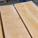 Edged alder boards with handwritten dimensions marked on the wood surface.