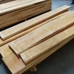Stack of kiln-dried edged alder lumber boards ready for shipment.